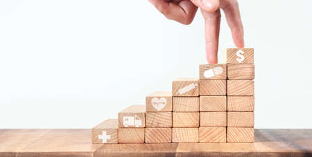 Wealth staircase concept.Chess figures on toy wooden ladder healthcare And Medicine conceptの写真素材