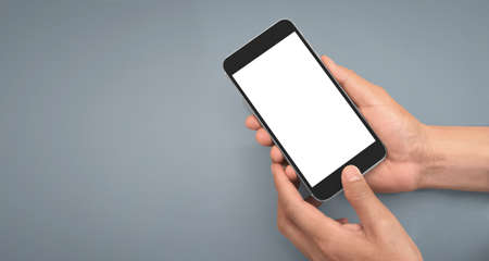 Hand holding smartphone device and touching screenの写真素材