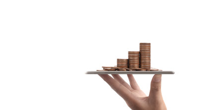 Coin and wealth concept. Loads of money on glass representing digital tabletの写真素材