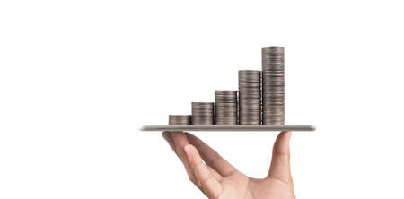 Coin and wealth concept. Loads of money on glass representing digital tabletの写真素材
