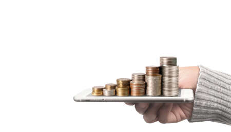 Coin and wealth concept. Loads of money on glass representing digital tabletの写真素材