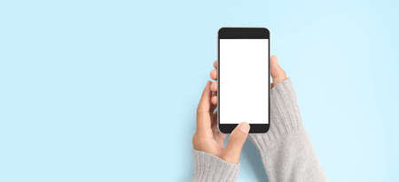 Hand holding smartphone device and touching screenの写真素材