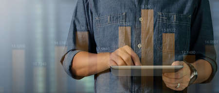 Hand touching  graphs of financial indicator and accounting market economy analysis chartの写真素材