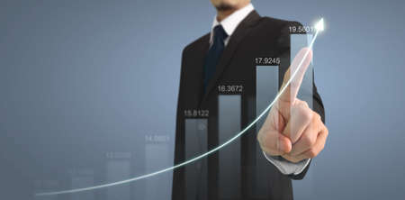 Businessman plan graph growth and increase of chart positive indicators in his businessの写真素材