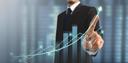 Businessman plan graph growth and increase of chart positive indicators in his businessの写真素材