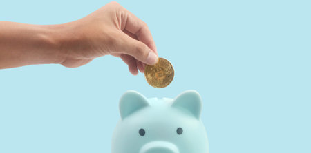 Bitcoin with financial investment in hand  concept and Piggy bankの写真素材