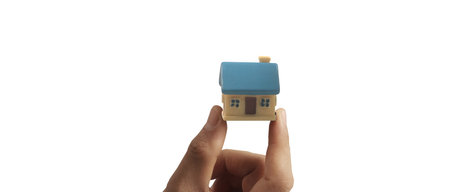 Hand holding  house model. property insurance and security Buy and rent house conceptの写真素材