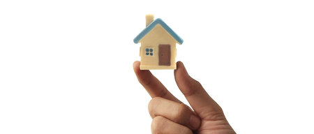 Hand holding  house model. property insurance and security Buy and rent house conceptの写真素材