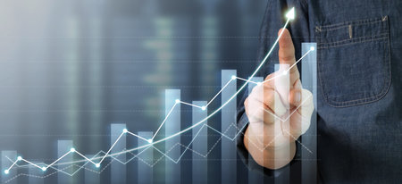 Businessman plan graph growth and increase of chart positive indicators in his businessの写真素材