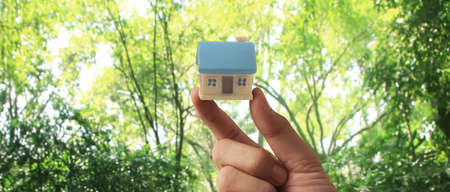 Hand holding  house model. property insurance and security Buy and rent house conceptの写真素材