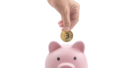 Bitcoin with financial investment in hand  concept and Piggy bankの写真素材
