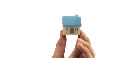 Hand holding  house model. property insurance and security Buy and rent house conceptの写真素材