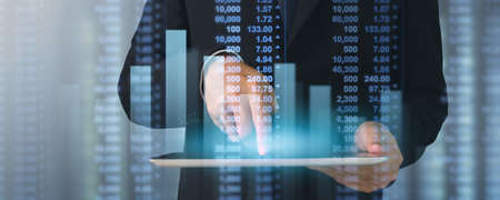 Businessman plan graph growth and increase of chart positive indicators in his business,tablet in handの写真素材