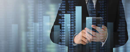 Businessman plan graph growth and increase of chart positive indicators in his business on smartphoneの写真素材