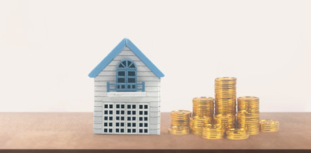 Model of detached miniature house mock up and coins. property real estate investment conceptの写真素材