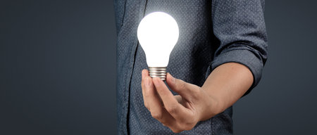 Humans hold light bulbs in hand innovative technology and creativity. creative idea light bulbsの写真素材