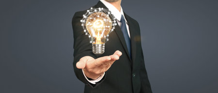 Humans hold light bulbs in hand innovative technology and creativity