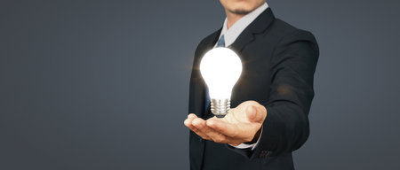 Humans hold light bulbs in hand innovative technology and creativityの写真素材