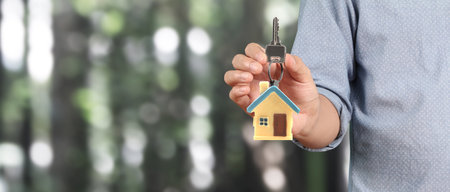 Real estate agent handing over a house keys in handの写真素材