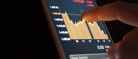 Hand touching mobile phone investing application. Stock market investment appの写真素材