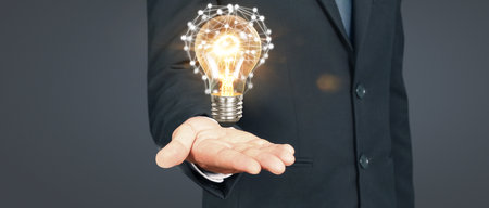Humans hold light bulbs in hand innovative technology and creativityの写真素材