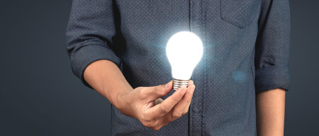 Humans hold light bulbs in hand innovative technology and creativity. creative idea light bulbsの写真素材