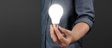 Humans hold light bulbs in hand innovative technology and creativity. creative idea light bulbsの写真素材
