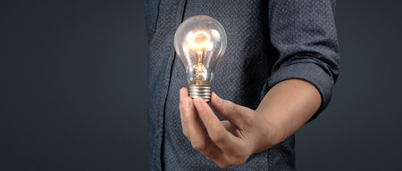 Humans hold light bulbs in hand innovative technology and creativity. creative idea light bulbsの写真素材