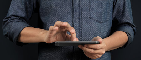 Man holding smartphone device  holding smartphone device and touching screenの写真素材