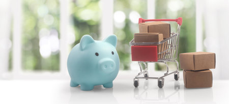 Toy shopping cart with boxes shopping and delivery concept. Consumer society trendの写真素材