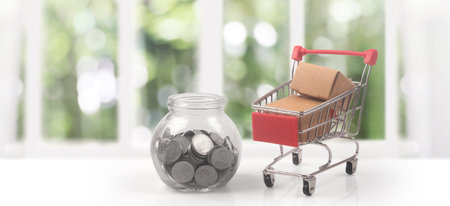 Toy shopping cart with boxes shopping and delivery concept. Consumer society trendの写真素材