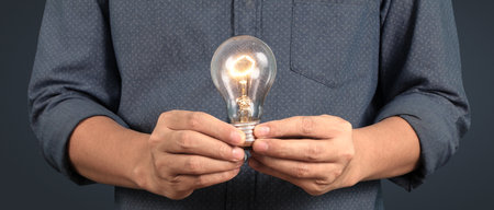 Humans hold light bulbs in hand innovative technology and creativity. creative idea light bulbsの写真素材
