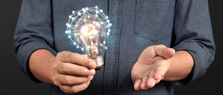 Humans hold light bulbs in hand innovative technology and creativity. creative idea light bulbsの写真素材