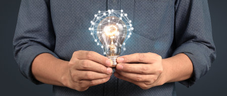 Humans hold light bulbs in hand innovative technology and creativity. creative idea light bulbsの写真素材