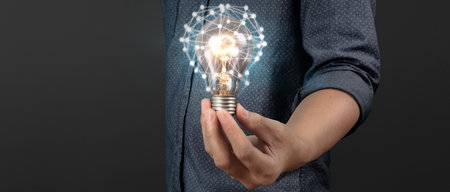 Humans hold light bulbs in hand innovative technology and creativity. creative idea light bulbsの写真素材