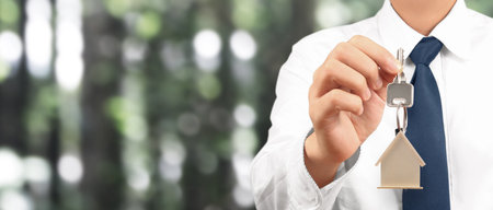 Real estate agent handing over a house keys in handの写真素材