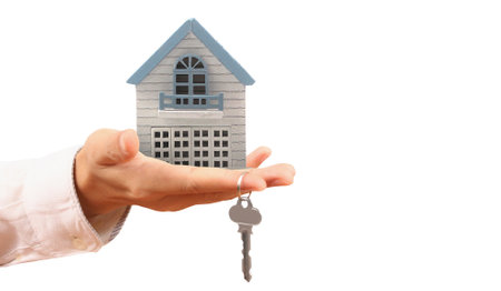 Real estate agent handing over a house keys in handの写真素材
