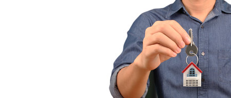 Real estate agent handing over a house keys in handの写真素材