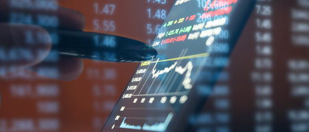 Hand touching mobile phone investing application. Stock market investment appの写真素材