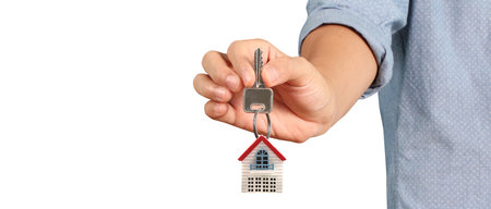 Real estate agent handing over a house keys in handの写真素材