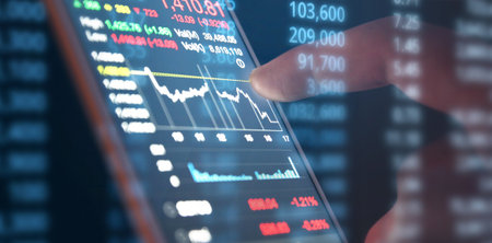 Hand touching mobile phone investing application. Stock market investment appの写真素材