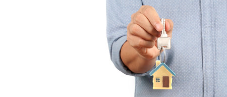 Real estate agent handing over a house keys in hand