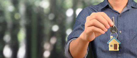Real estate agent handing over a house keys in handの写真素材