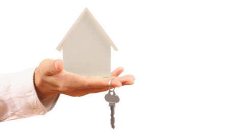 Real estate agent handing over a house keys in handの写真素材