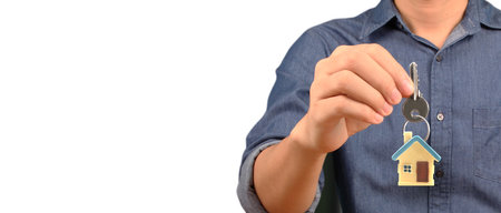 Real estate agent handing over a house keys in handの写真素材
