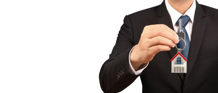 Real estate agent handing over a house keys in handの写真素材