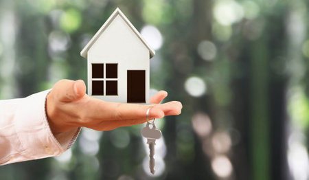 Real estate agent handing over a house keys in handの写真素材