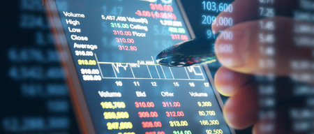 Hand touching mobile phone investing application. Stock market investment appの写真素材