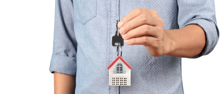 Real estate agent handing over a house keys in handの写真素材