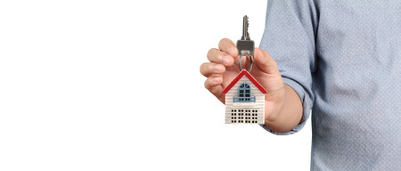Real estate agent handing over a house keys in handの写真素材